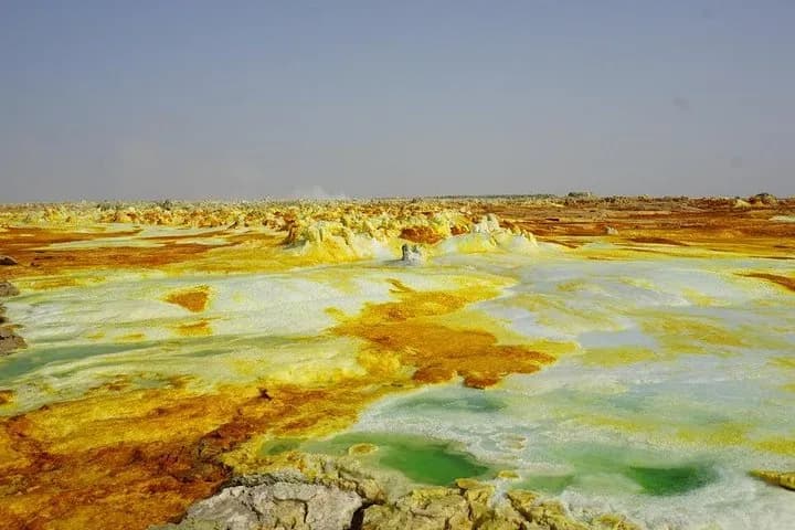 One of Earth's most extreme environments - the hottest inhabited place on Earth, 125m below sea level. Home to active Erta Ale volcano with permanent lava lake, colorful sulfur springs, and salt flats